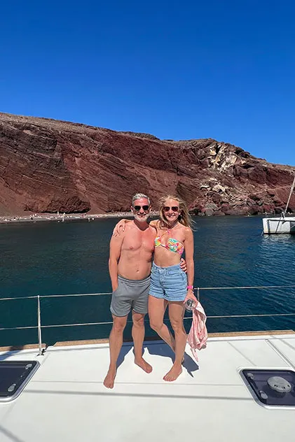 couple at a catamaran cruise red beach santorini