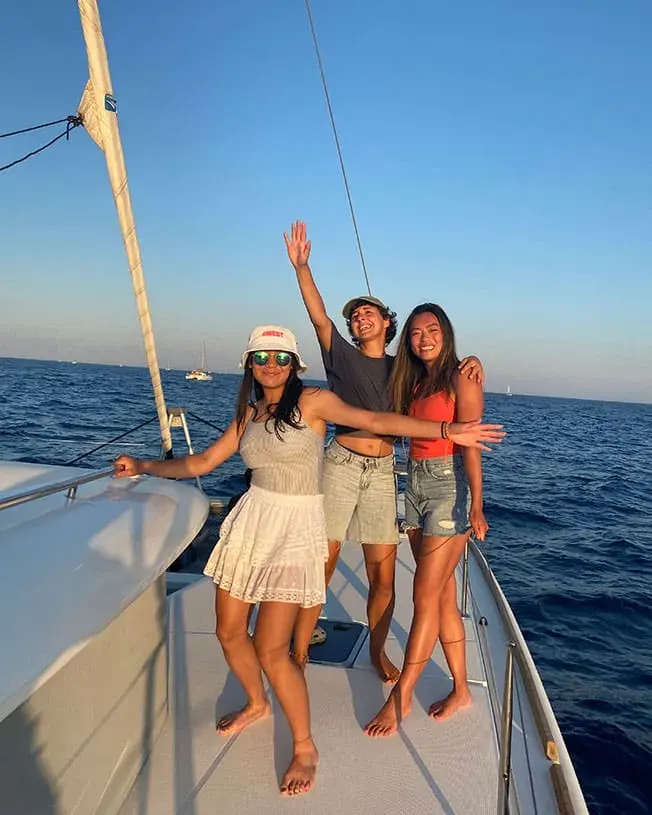 crew and friends sailing in santorini catamaran cruise