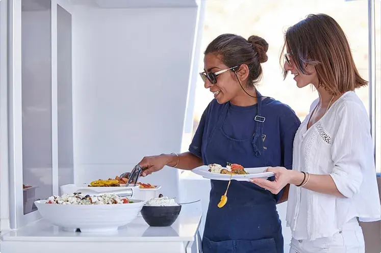 Meal onboard with BBQ and open bar drinks on catamaran cruise