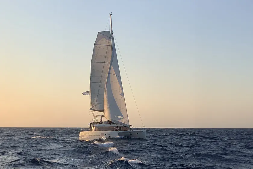 Semi-private catamaran cruise in Santorini at golden hour