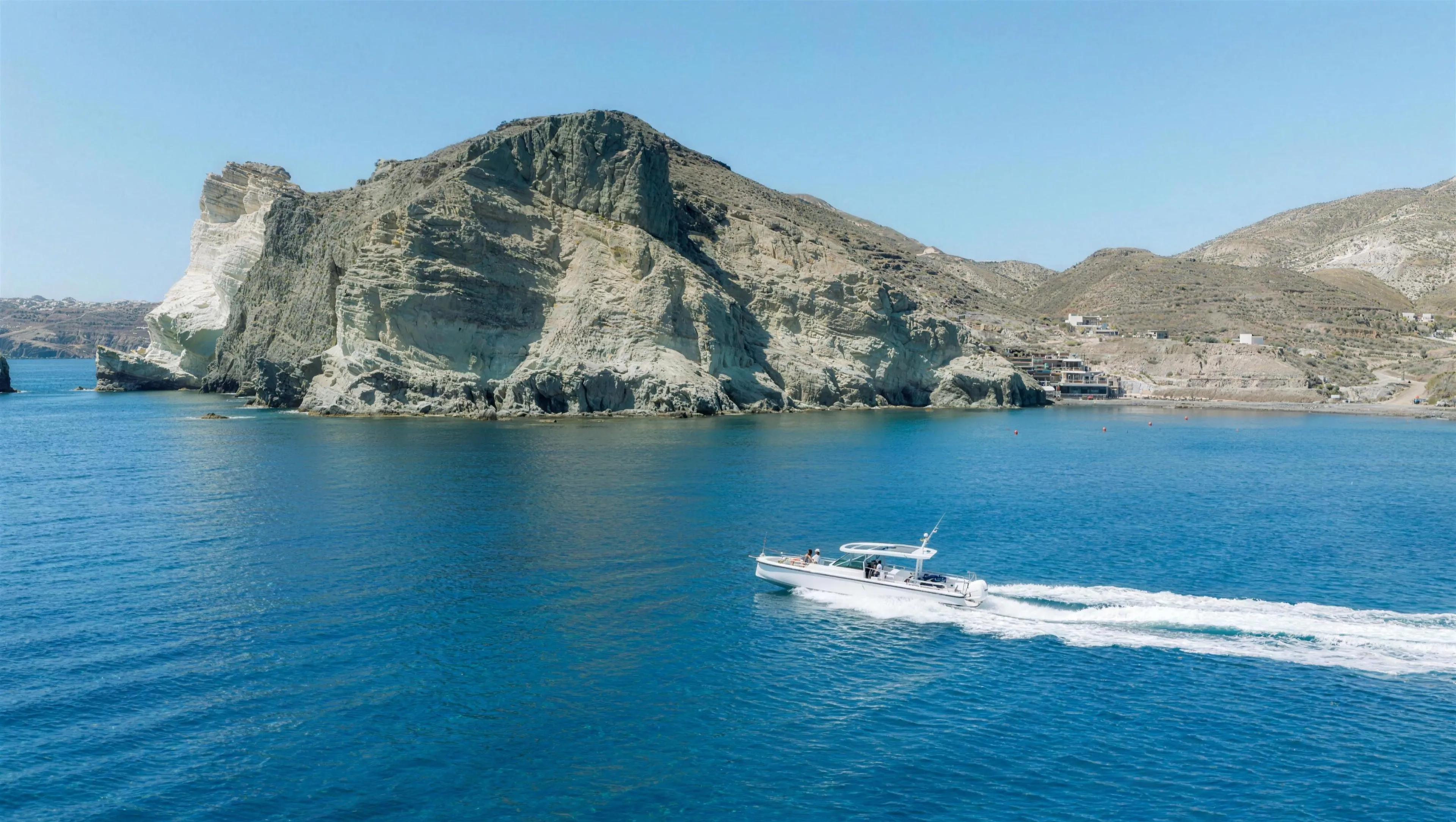 Axopar 37 private motor yacht cruising past the white cliffs of Santorini