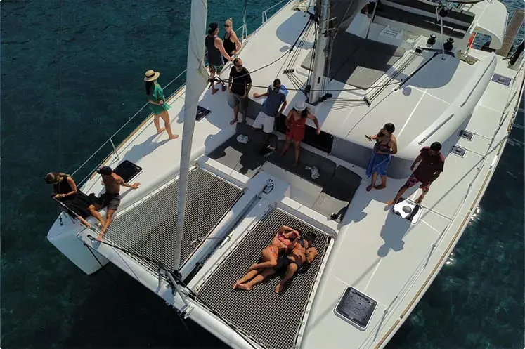 Guests on shared group sailing catamaran cruise Santorini
