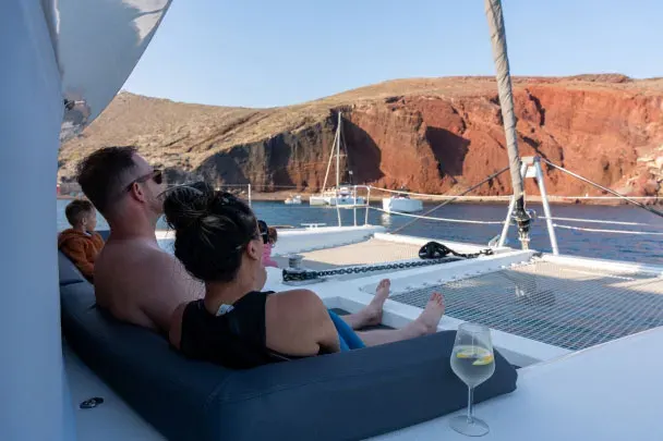 Romantic couple on catamaran tour at Red Beach Santorini