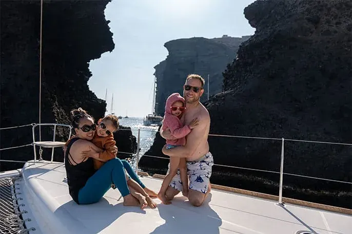 family with baby on yacht near Red Beach Santorini
