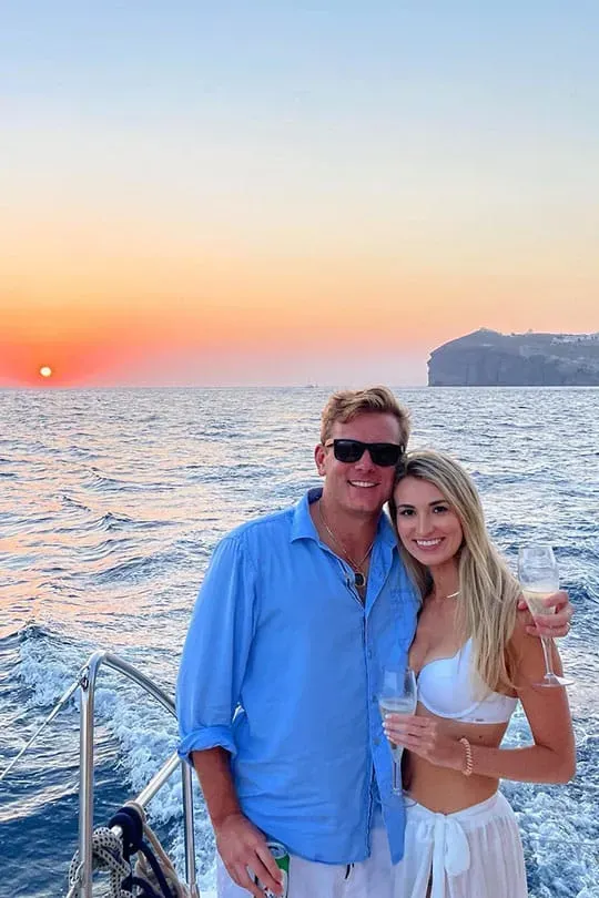 couple enjoying champagne on Santorini sunset yacht tour