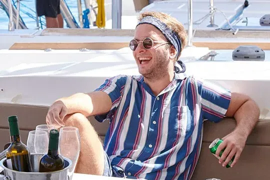 relaxing with wine on catamaran net at sunset cruise