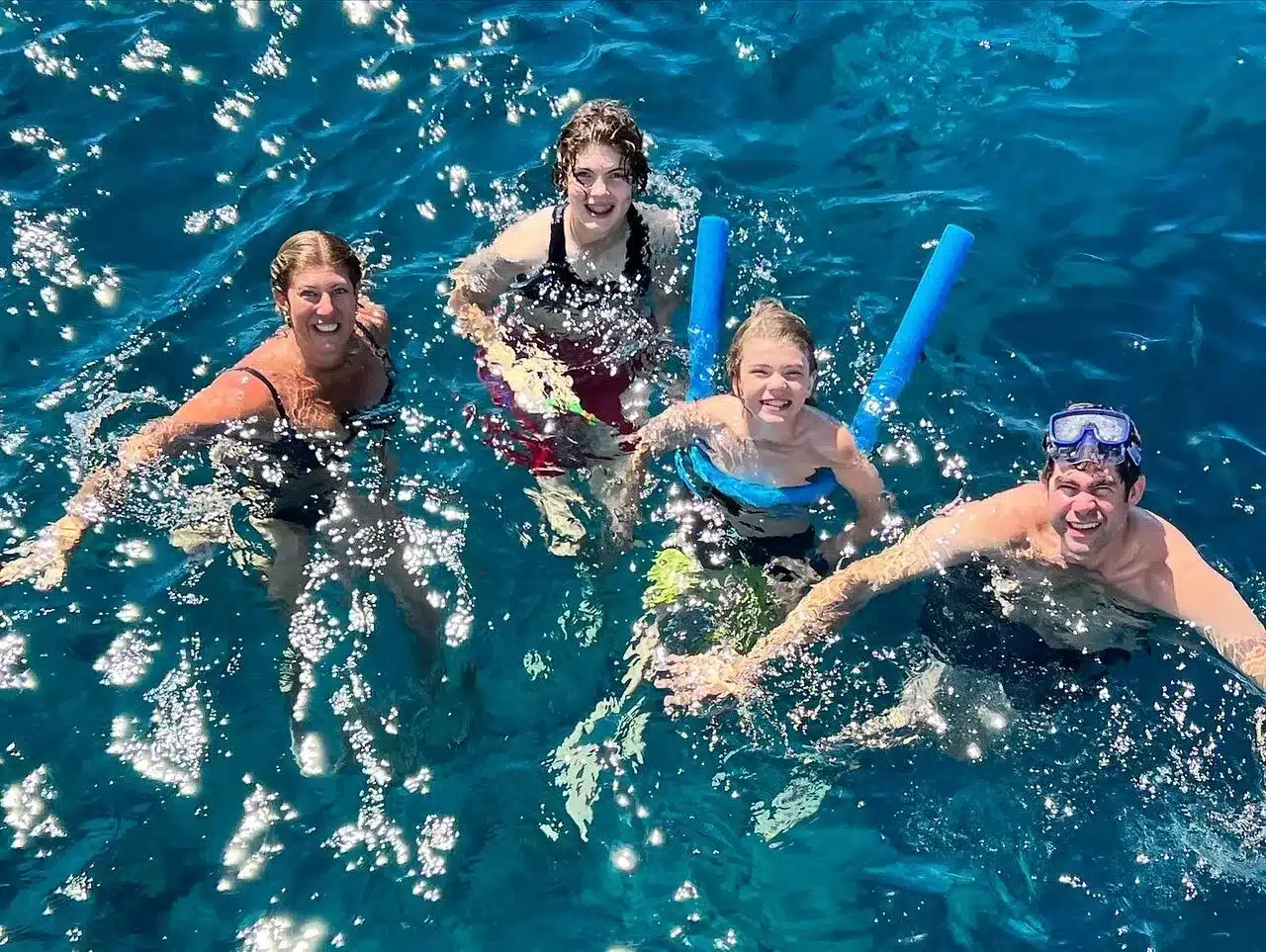 Guests swimming at the volcano hot springs in Santorini